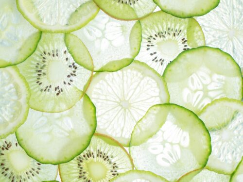 Close-up of fresh citrus and kiwi slices showcasing vibrant textures and colors.
