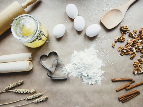 A collection of baking essentials including flour, eggs, and nuts, perfect for homemade recipes.